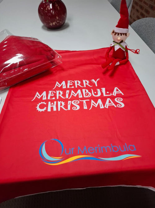 Red Merry Merimbula Christmas item with Our Merimbula logo and an elf